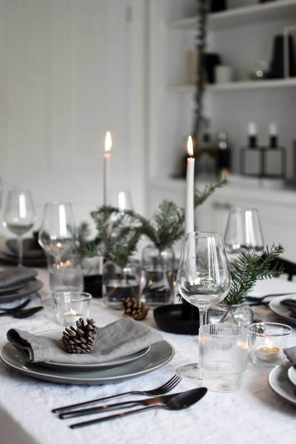 Minimalist Christmas table styling with fir, candles & pine cones | These Four Walls